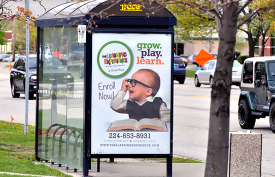 Image of a transit shelter ad for a local business