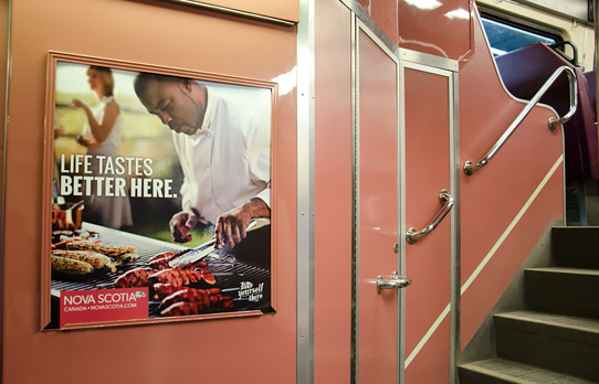 Image of commuter rail interior car card advertising in Boston