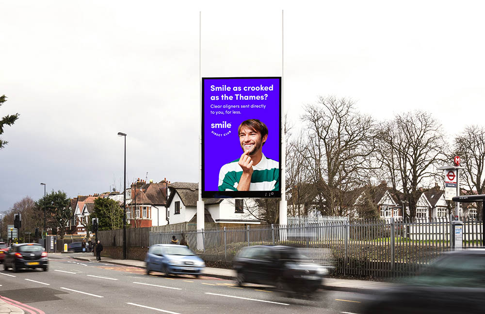 A digital billboard with traffic passing by.