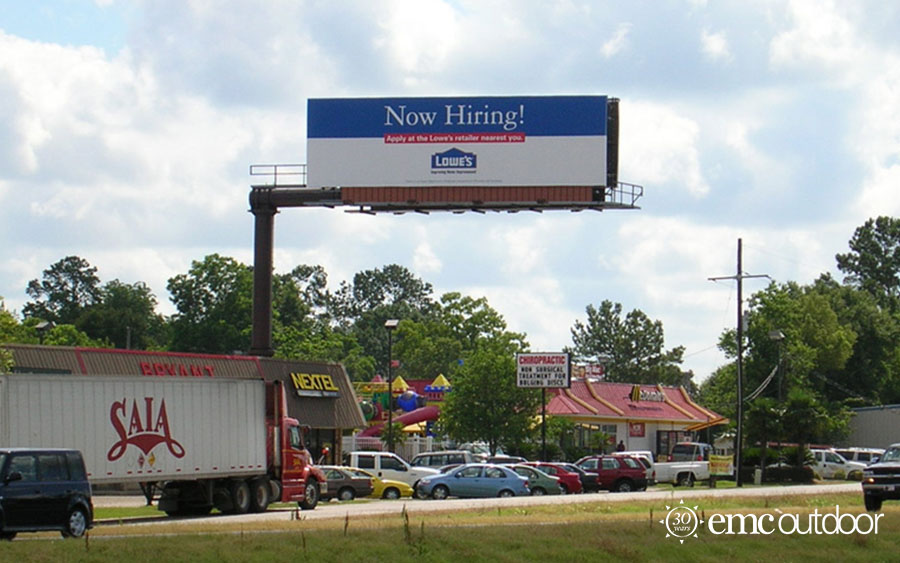 A billboard featuring a Now Hiring message