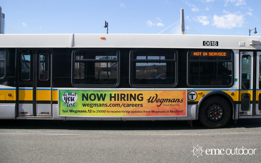 A bus with a now hiring ad