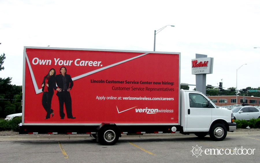 A mobile billboard with a now hiring message