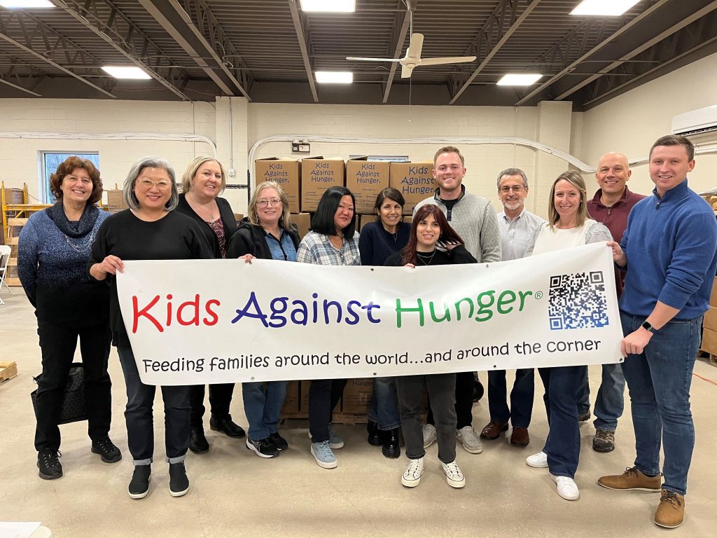 Our agency team helping pack meals for those dealing with food insecurity