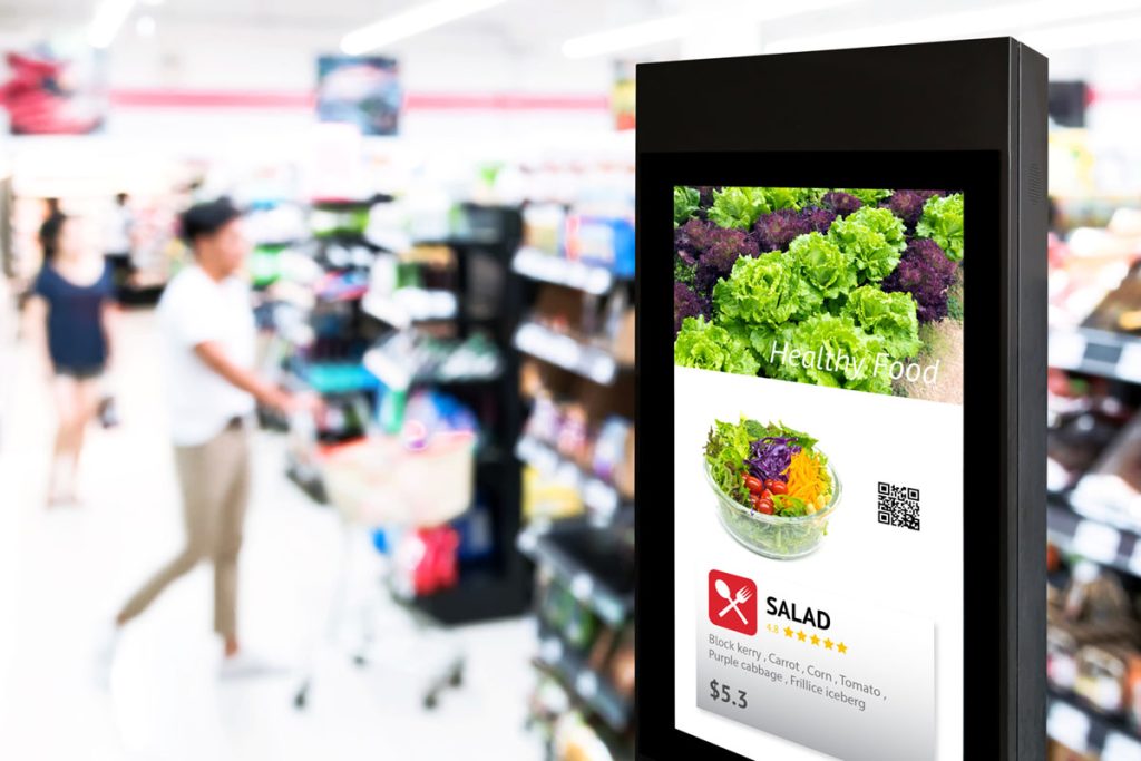 image of a digital advertising kiosk in a supermarket which will be an out of home media trend for 2024