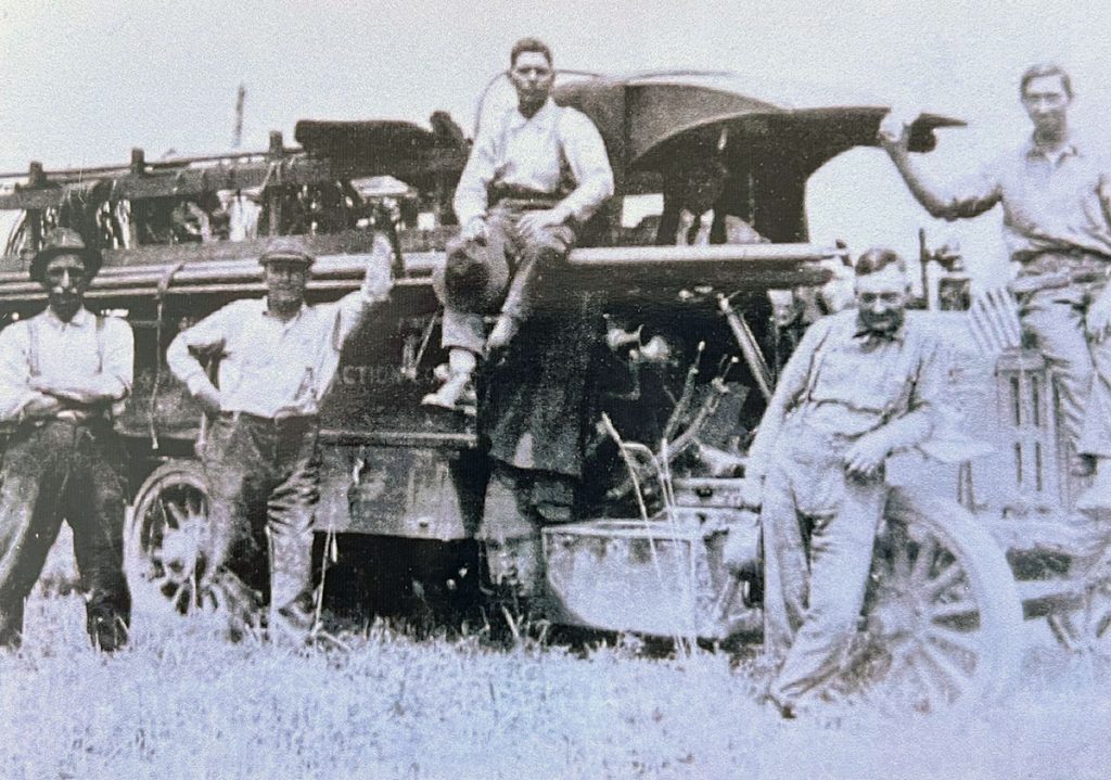 an old picture of men on a truck