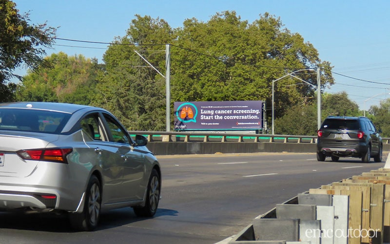 Car approaching out of home billboard on the road