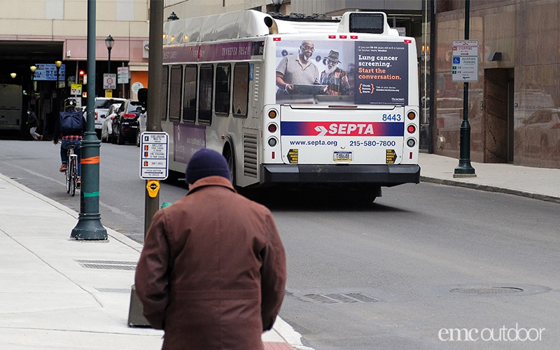 out of home bus wrap driving through underserved area