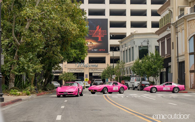 Peacock pink corvettes driving through hollywood