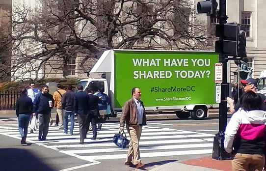 Image of mobile billboard advertising vehicle being used to reach consumers