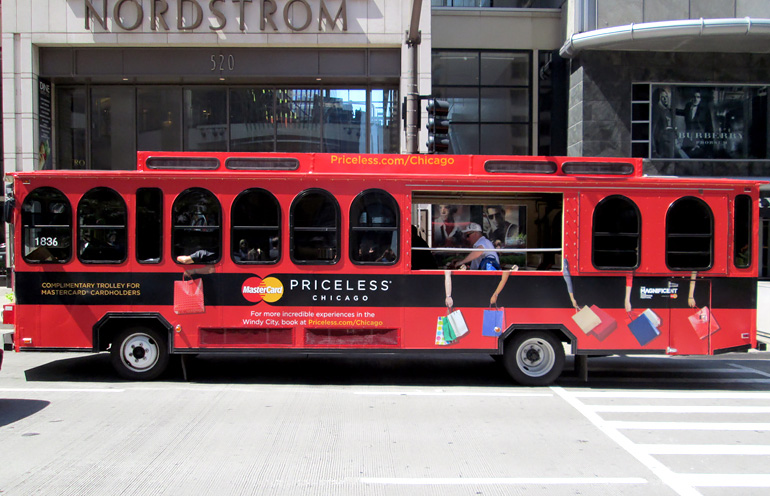 Image of wrapped trolley advertising on Chicago's Magnificent Mile for a major credit card provider