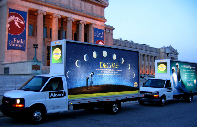 Image of two mobile billboards in front of the Field Museum in Chicago