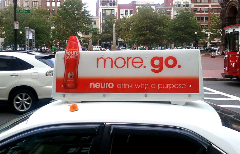 Image of taxi advertising in Boston for a beverage product