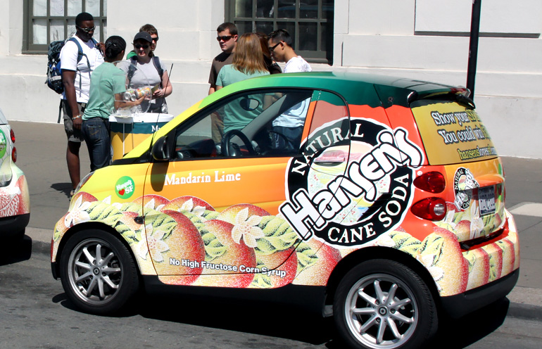 Image of a wrapped smart car being used to advertise a beverage product in San Francisco